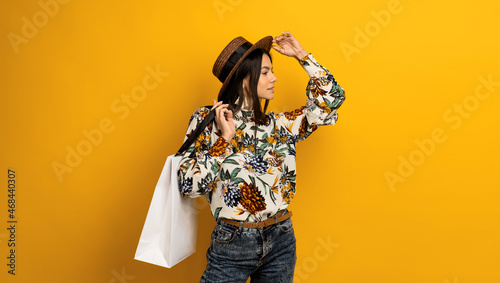 beautiful attractive stylish brunette woman holding white shopping bag