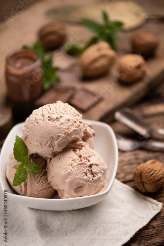 Hazelnut and chocolate icecream in a cup closeup.