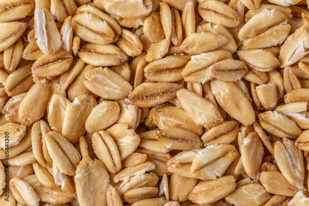 Rolled oat, oat flakes background or texture. Close up, directly above.Heap of dry rolled oats isolated. Rolled oat, oat flakes background or texture. Close up, directly above.Heap of dry rolled oats isolated.