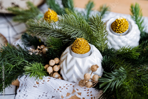 New year and Christmas.Candles in the form of cones, unusual interior, a bouquet of spruce Preparation for the holiday.Holiday with family, winter holidays