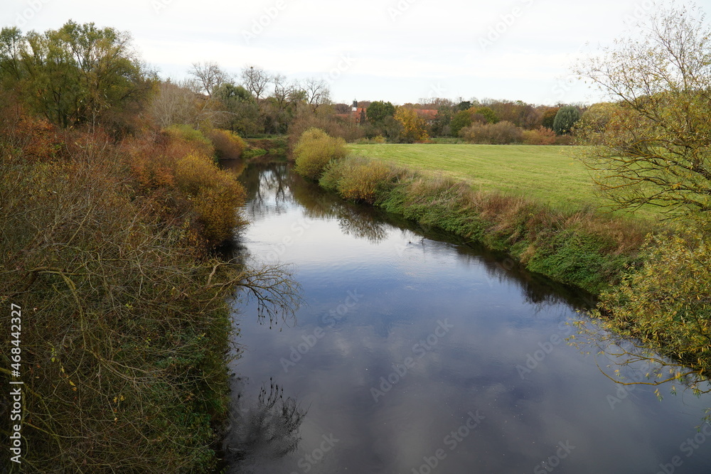 Idyllic autumn scene with the river Leine and the monastery church Marienwerder in the background, Hannover county, Lower Saxony, Germany. Idyllic autumn scene with the river Leine and the monastery church Marienwerder in the background, Hannover county, Lower Saxony, Germany.
