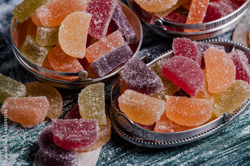 Dessert marmalade in the form of lemon and orange slices. The sweetness of jelly candy. photo