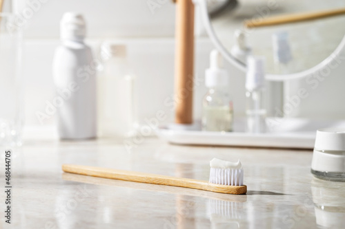 Eco-friendly bamboo toothbrush with toothpaste in the bathroom.