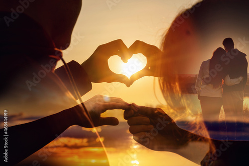 Double exposure of young couple of lovers against the background of a sunset.