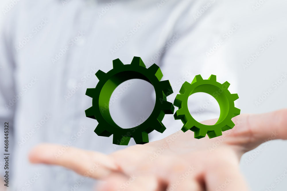 Mechanism green gears and cogs at work on black background. Industrial machinery