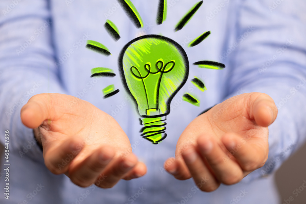 Hands holding green nature in the light bulb Hands holding green nature in the light bulb