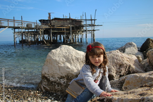 beautiful little girl playing in the beach on the trabocchi coast abruzzo italy