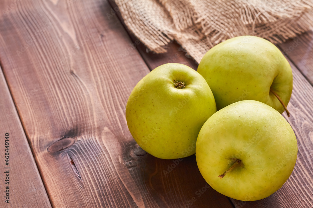 golden delicious apple on brown background golden delicious apple on brown background