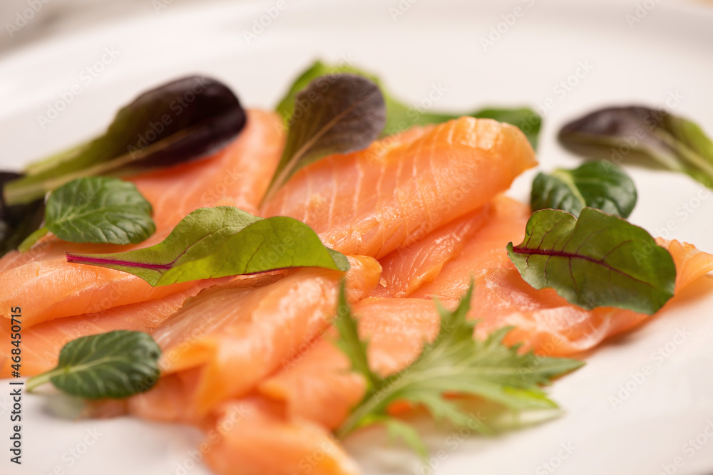 Smoked salmon as closeup on a white plate Smoked salmon as closeup on a white plate