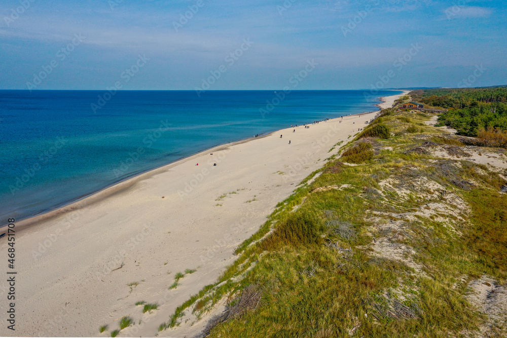 White sand beach. View to Baltic Sea Costline. Curonian Spit, Aerial view of the sea coast with waves. Travel and vacation concept. White sand beach. View to Baltic Sea Costline. Curonian Spit, Aerial view of the sea coast with waves. Travel and vacation concept.