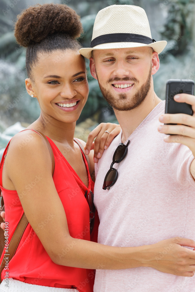 young couple pose for holiday selfie