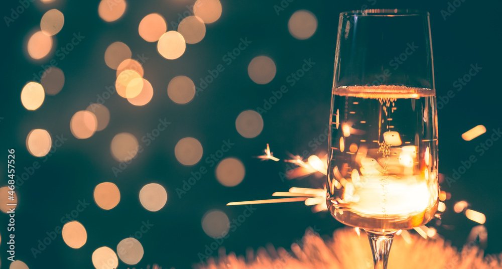 champagne glass with sparkler, festive background, vintage colors