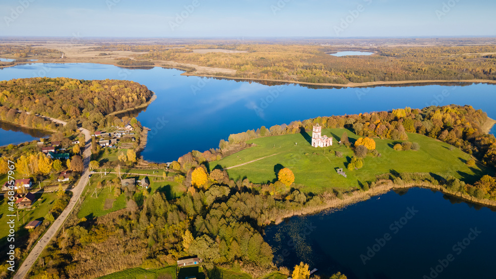 Top view autumn landscape with yellow trees on bank of lake. Nature concept.
