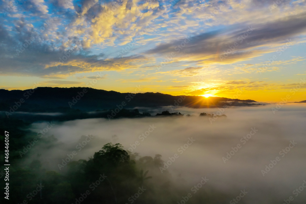 Beautiful cloudscape during sunrise over a tropical forest in the Amazon of Ecuador covered in fog