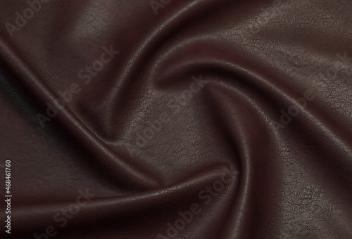 brown artificial leather with waves and folds on PVC base