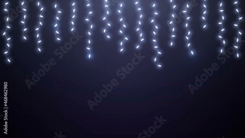 Hanging glowing garlands with white light bulbs on dark background