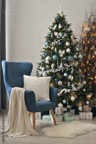 New Year's interior in blue shades with a large Christmas tree