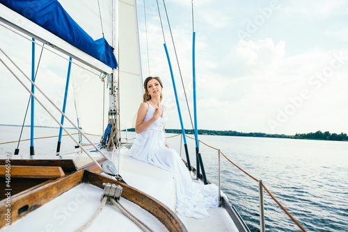 young girl on deck of sailing wooden yacht