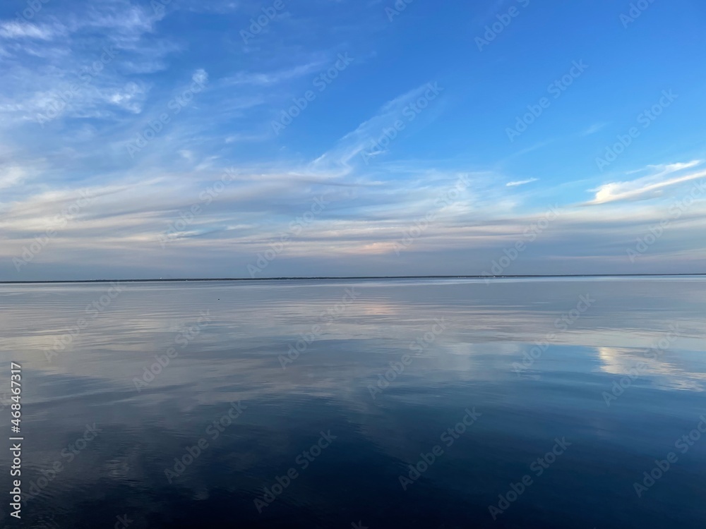 blue mood sunset skies with reflections on calm bay water blue mood sunset skies with reflections on calm bay water