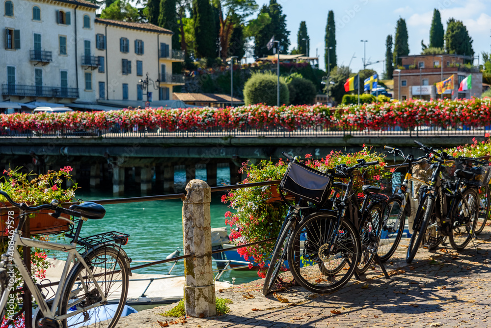 Peschiera di Garda, Italy - October 22, 2021: Electric bicycles parked by tourists who rent them to tour the city.