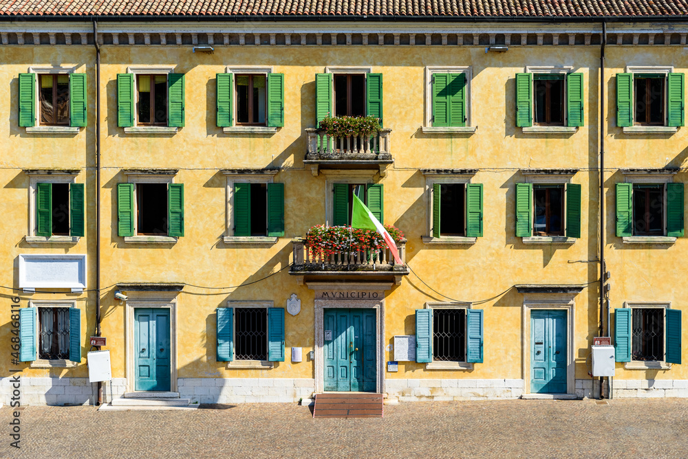 Facade of a public building of the Italian municipality facing the sun.