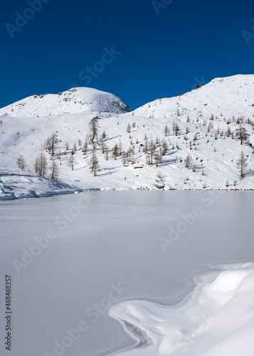 Frozen alpine lake on the swiss alps photo