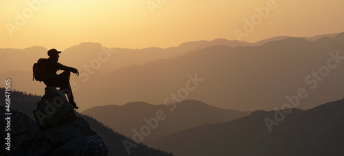 silhouette of a person on a mountain top