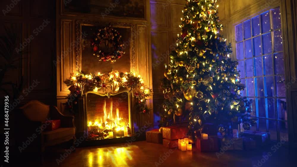 Christmas and New Year interior decoration. Green tree decorated with toys, gifts, present boxes, flashing garland, illuminated lamps. Fireplace with burning fire. Cozy Christmas atmosphere. 4K Loop