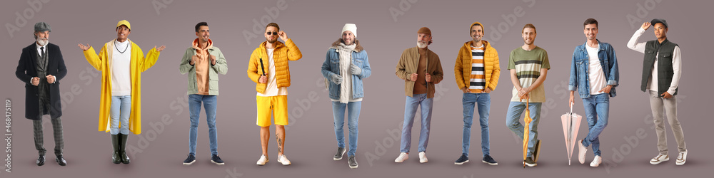 Group of stylish men in autumn clothes on grey background Group of stylish men in autumn clothes on grey background