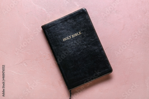 Holy Bible book on pink background