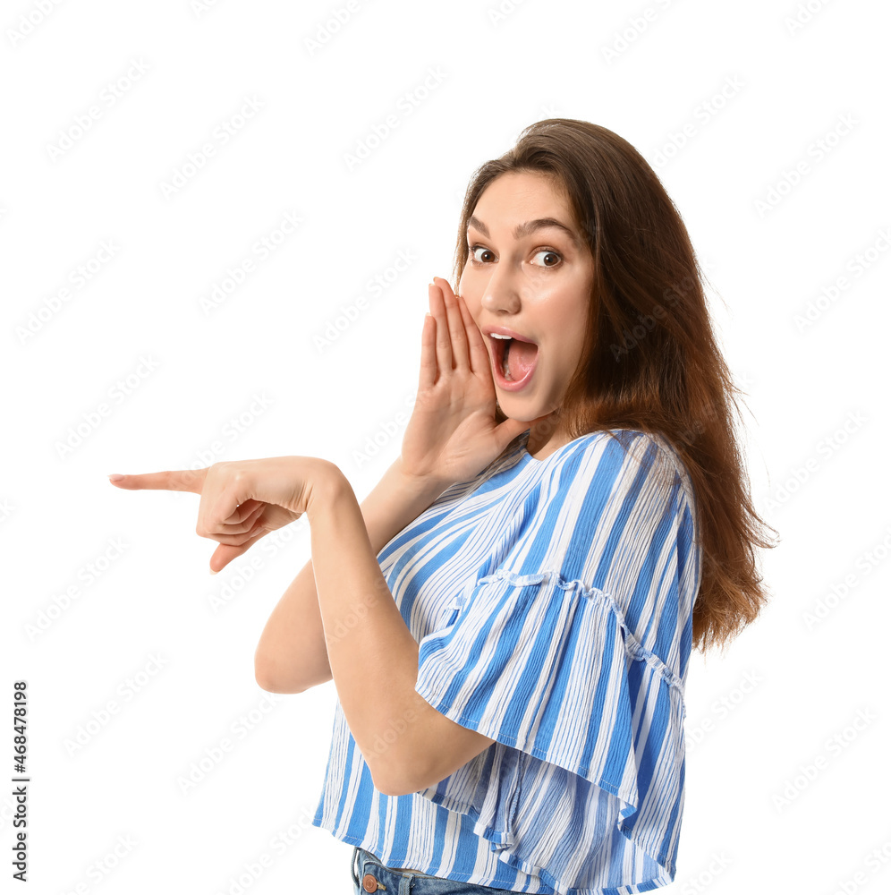 Surprised young gossip woman pointing at something on white background Surprised young gossip woman pointing at something on white background