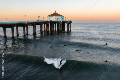 Surfers near the Manhattan Beach Pier in Southern California.