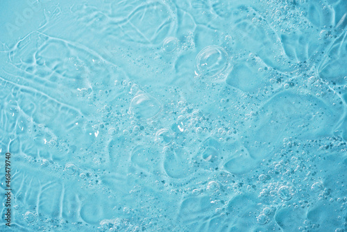 Close up macro Aloe vera gel cosmetic texture blue background with bubbles. Lemongrass gel skincare product. antibacterial liquid with aloe vera, moisturizing. Safe and environmental friendly. © Serenkonata