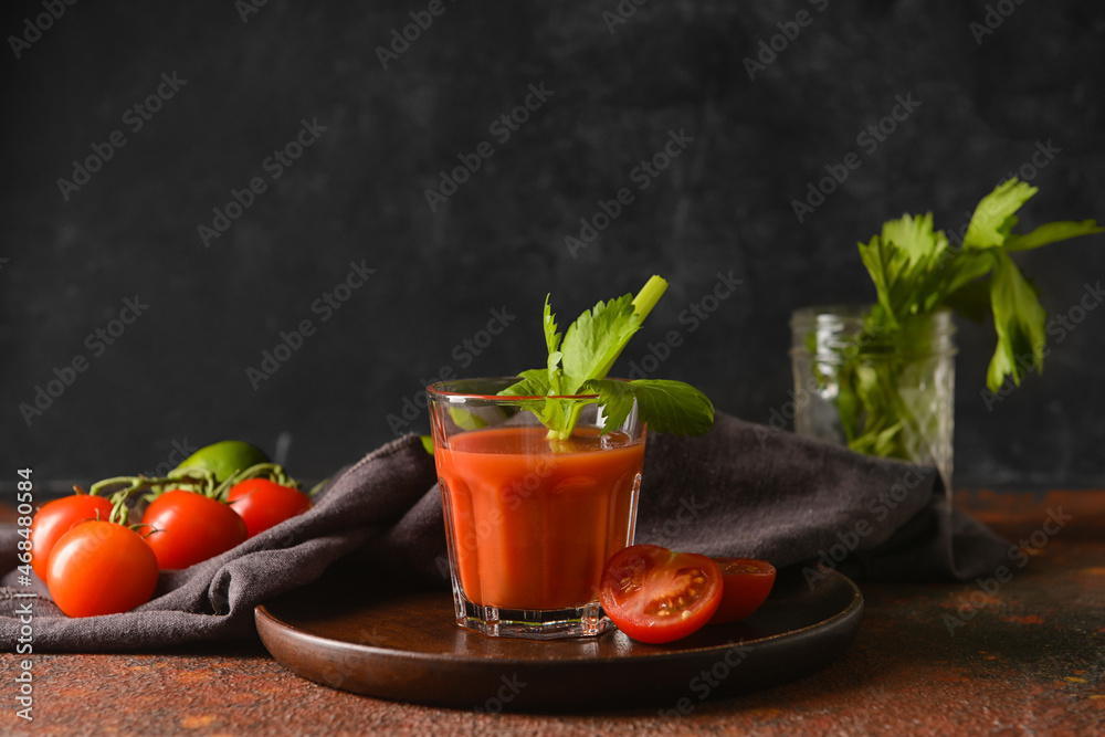 Glass of bloody mary with celery and tomatoes on table Glass of bloody mary with celery and tomatoes on table