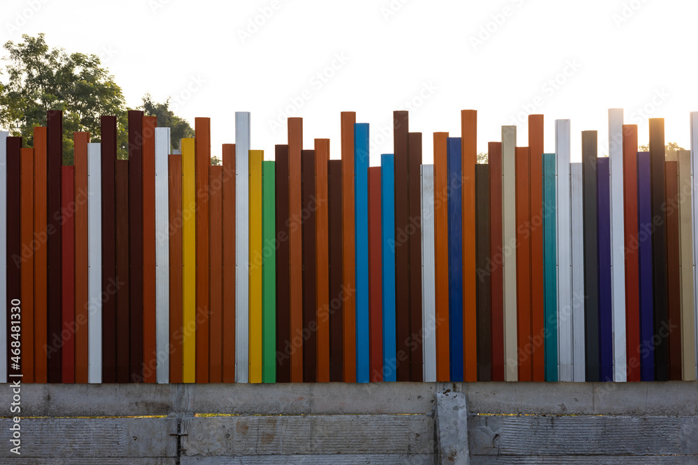 The background view of the fence, walls, strips of steel poles, in many different colors. The background view of the fence, walls, strips of steel poles, in many different colors.