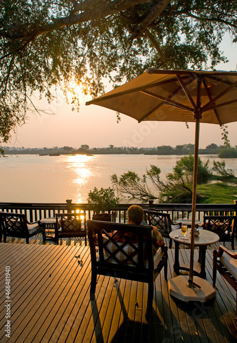 Man relaxing in a chair near Victoria Falls, Zambia.