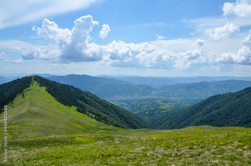 Beautiful mountain landscape, with mountain hills and meadow covered green grass and forest under cloudy sky in summer. Carpathian Mountains, Ukraine Beautiful mountain landscape, with mountain hills and meadow covered green grass and forest under cloudy sky in summer. Carpathian Mountains, Ukraine
