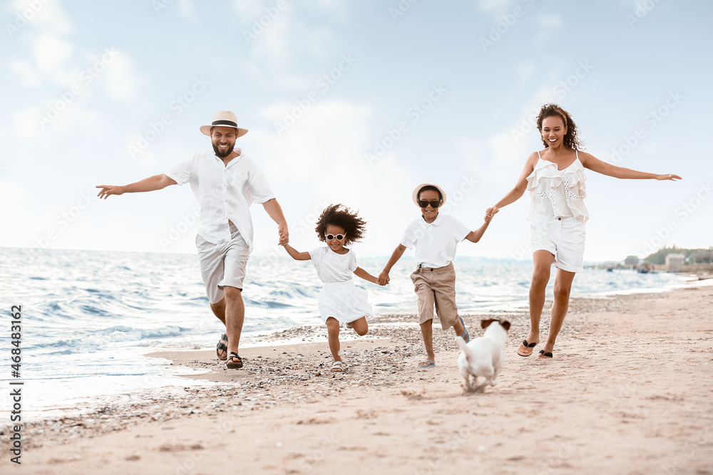 Happy family running on sea beach Happy family running on sea beach