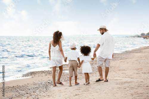 Happy family walking on sea...