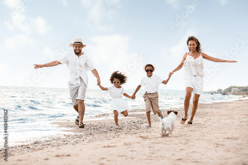 Happy family running on sea...