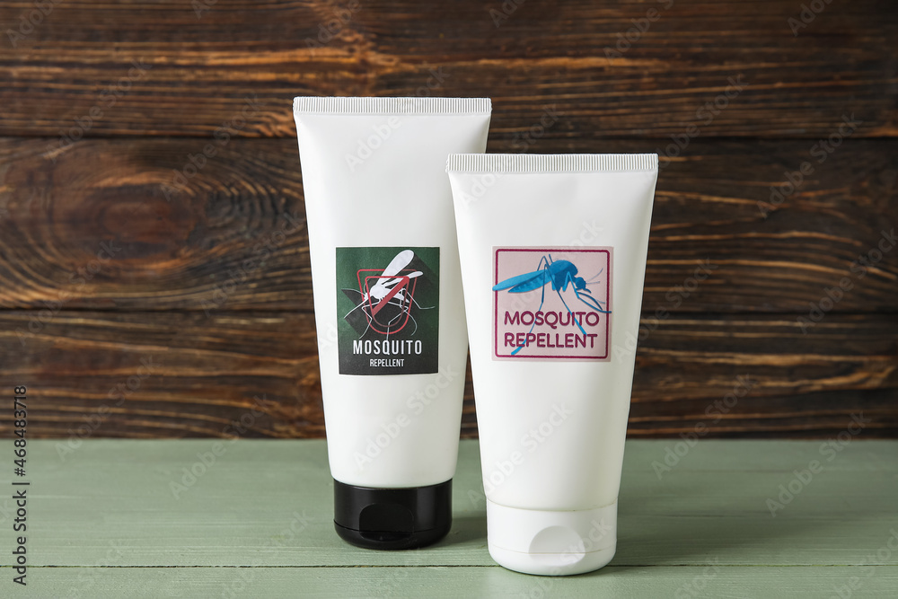 Mosquito repellent cream on dark wooden background Mosquito repellent cream on dark wooden background
