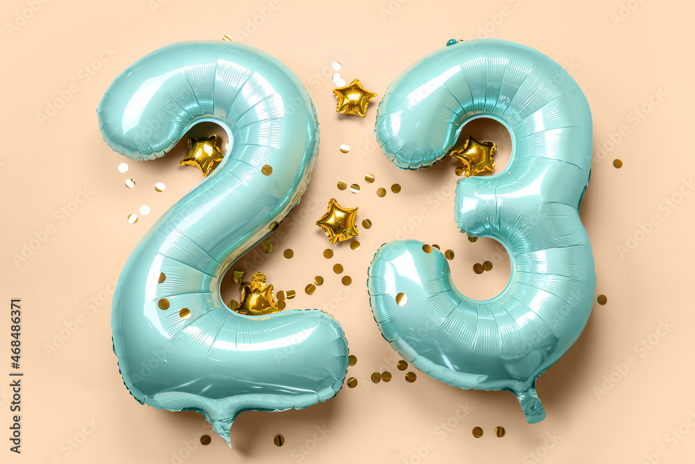 Figure 23 made of balloons and confetti on beige background - obrazy, fototapety, plakaty 