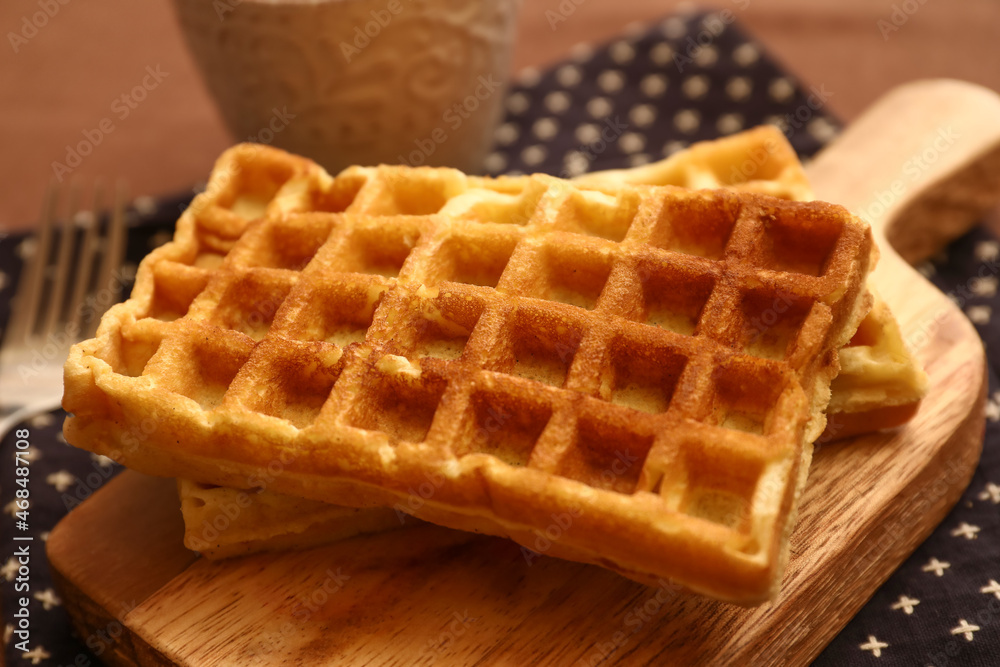 Wooden board of tasty Belgian Waffles on table in cafe Wooden board of tasty Belgian Waffles on table in cafe