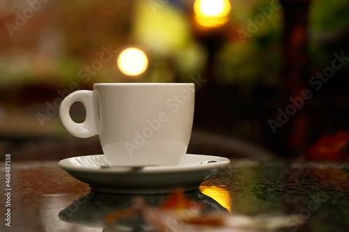 Cup of hot tea on table in outdoor cafe