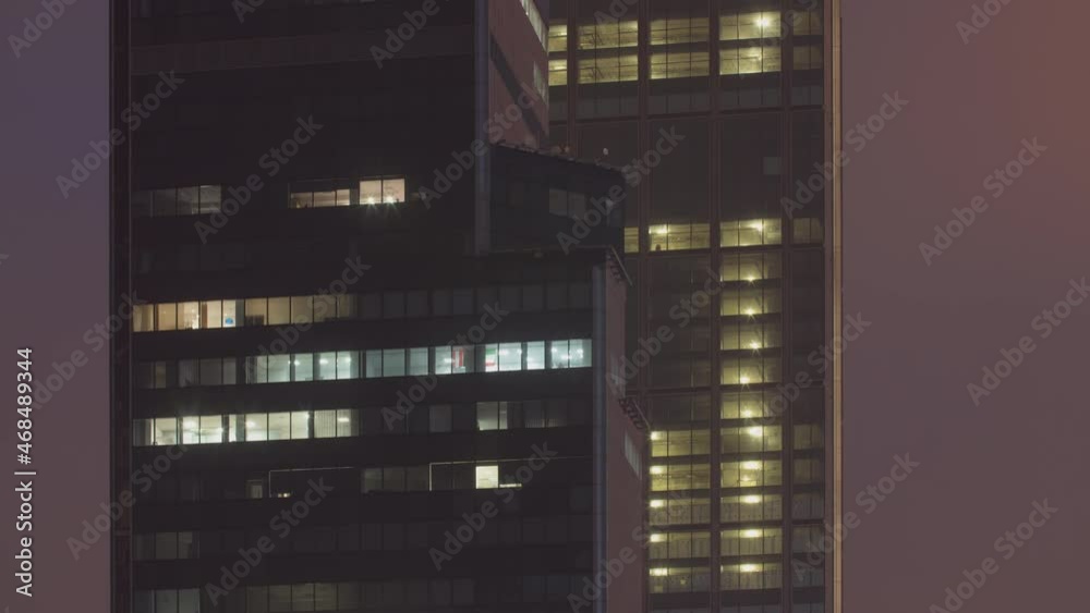 Time lapse building windows lights at night, business center building facade. High skyscraper residential glass surface. Lights in building windows turn on and off Time lapse building windows lights at night, business center building facade. High skyscraper residential glass surface. Lights in building windows turn on and off