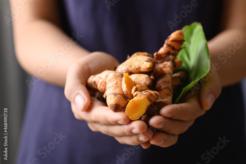 Fresh turmeric holding by hand, Food ingredients in Asian food and used in beauty spa and herbal medicine photo