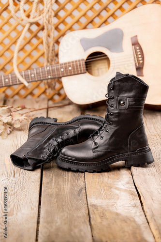 Fashion leather shoes for autumn, spring, European winter. Boots for a modern grunge woman. Women's black boots with laces isolated on white. Black Leather Army Boots. Autumn. Fashion. Style.