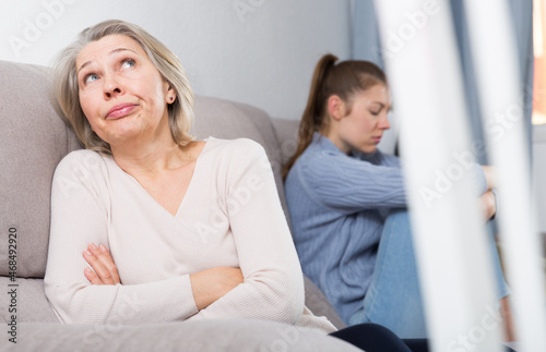 Portrait of senior woman and her adult daughter offended at each other