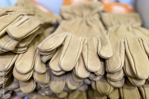 Stack of leatherette industrial gloves up for sale in the market .Stack of leatherette industrial gloves up for sale in the market .
