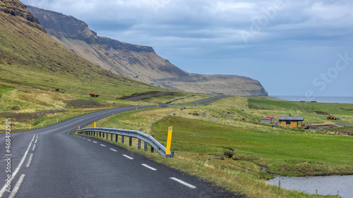 Scenic Snaefellsnesvegur high way through mountains along Atlantic coast in Iceland, with cloudy sky background
